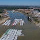 In this aerial view, barges, stranded by low water sit at the Port of Rosedale along the Mississippi River on October 20, 2022 in Rosedale, Mississippi. The lion fossil was found in the Rosedale area in October.